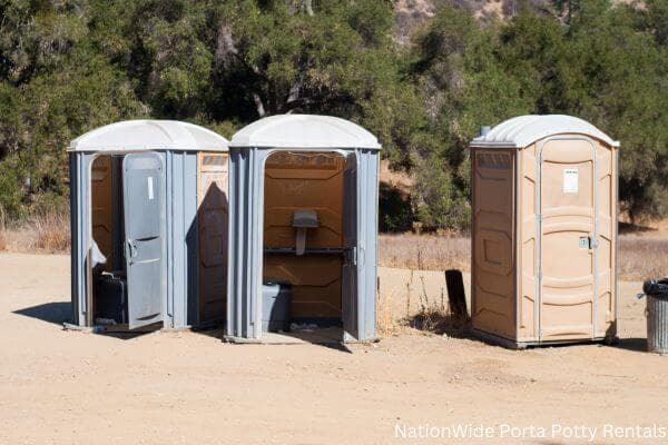 a clean row of portable restrooms for outdoor weddings or festivals in Newman Grove, NE